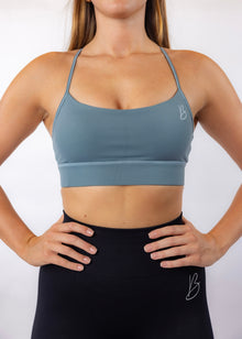 Smiling Woman in Sports Bra with Running Shoes Around Her Neck Stock Image  - Image of girl, teal: 1403825
